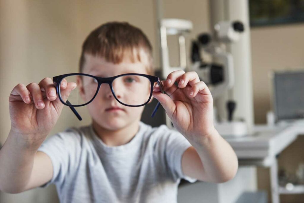 boy holding his new glasses