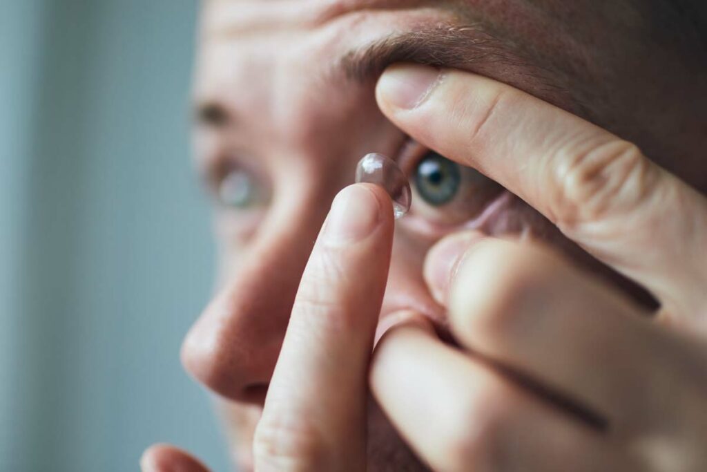 a man putting his contact lenses in